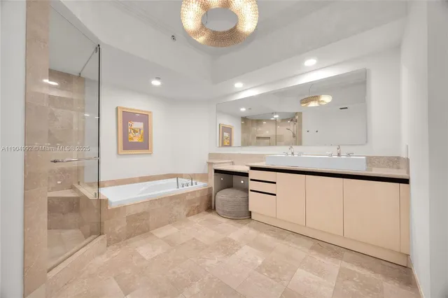 a spacious bathroom with a granite countertop tub shower and sink