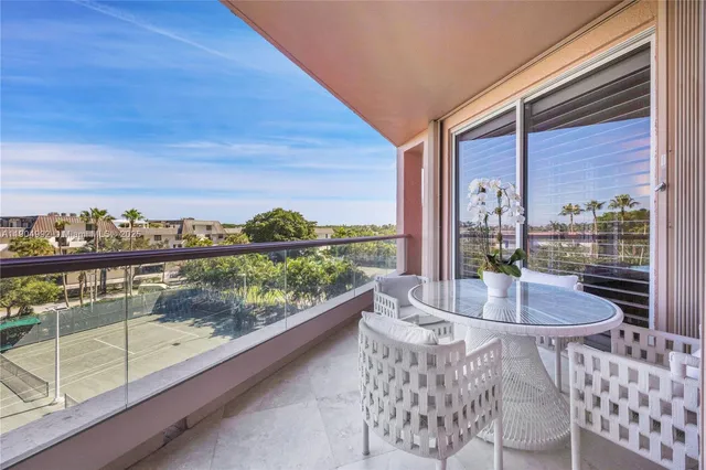 a view of a tall brick building next to a yard