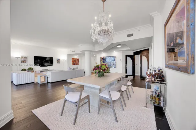 a view of a dining room with furniture and kitchen view