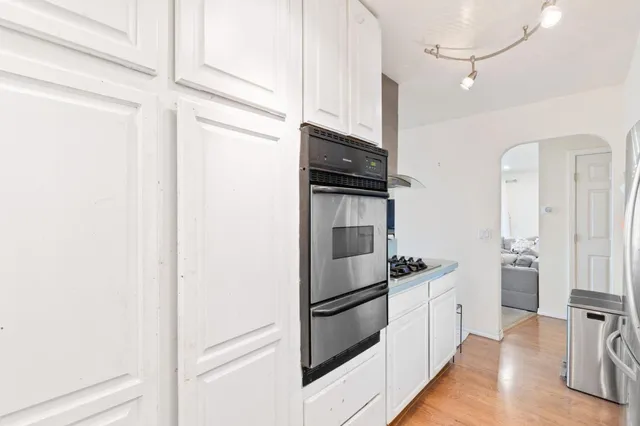 a kitchen with stainless steel appliances a refrigerator sink and microwave