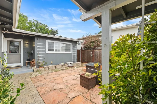 a view of a house with yard and sitting area