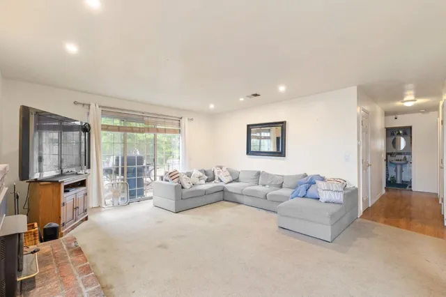 a living room with furniture and large window