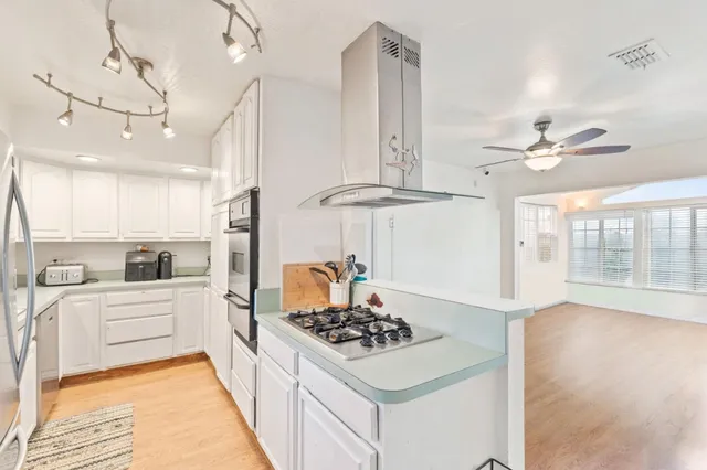 a kitchen with a stove a sink and a refrigerator