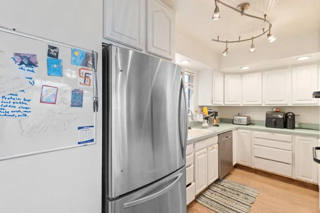 a white refrigerator freezer sitting inside of a kitchen