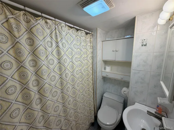 a white toilet sitting next to a bathroom sink