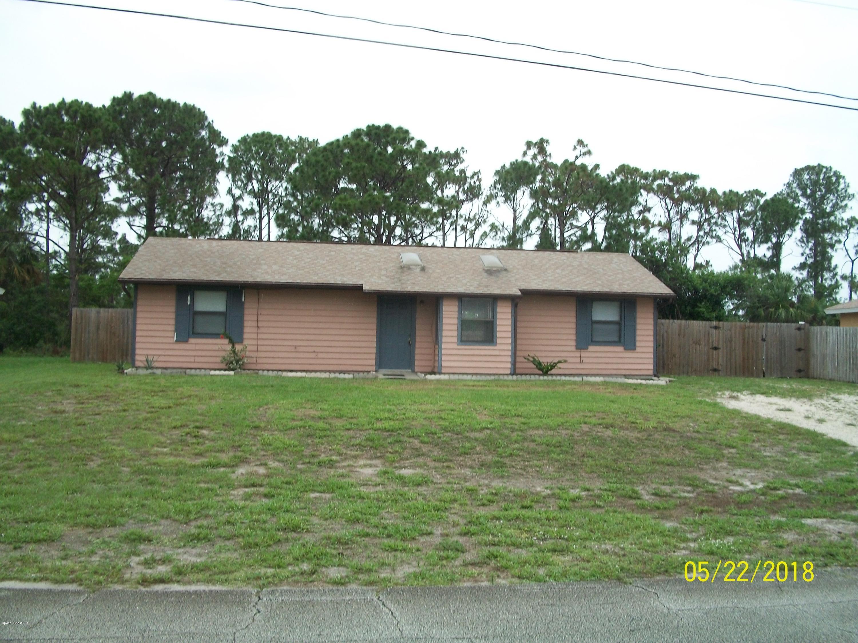 4910 Greenhill Street Cocoa, FL 32927 - Photo 1 of 11 a view of a backyard with plants and a garden