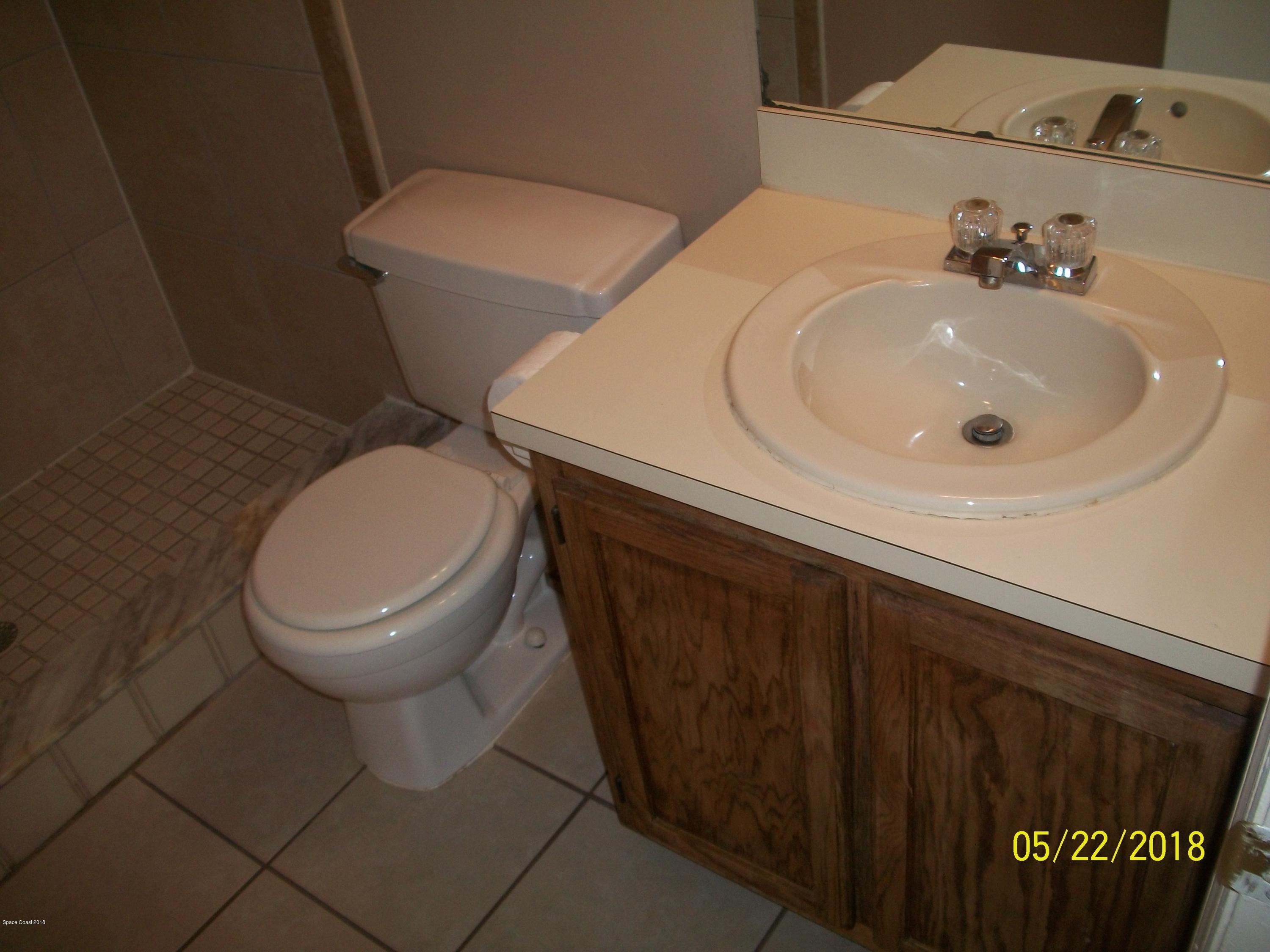 4910 Greenhill Street Cocoa, FL 32927 - Photo 11 of 11 a bathroom with a sink and a toilet