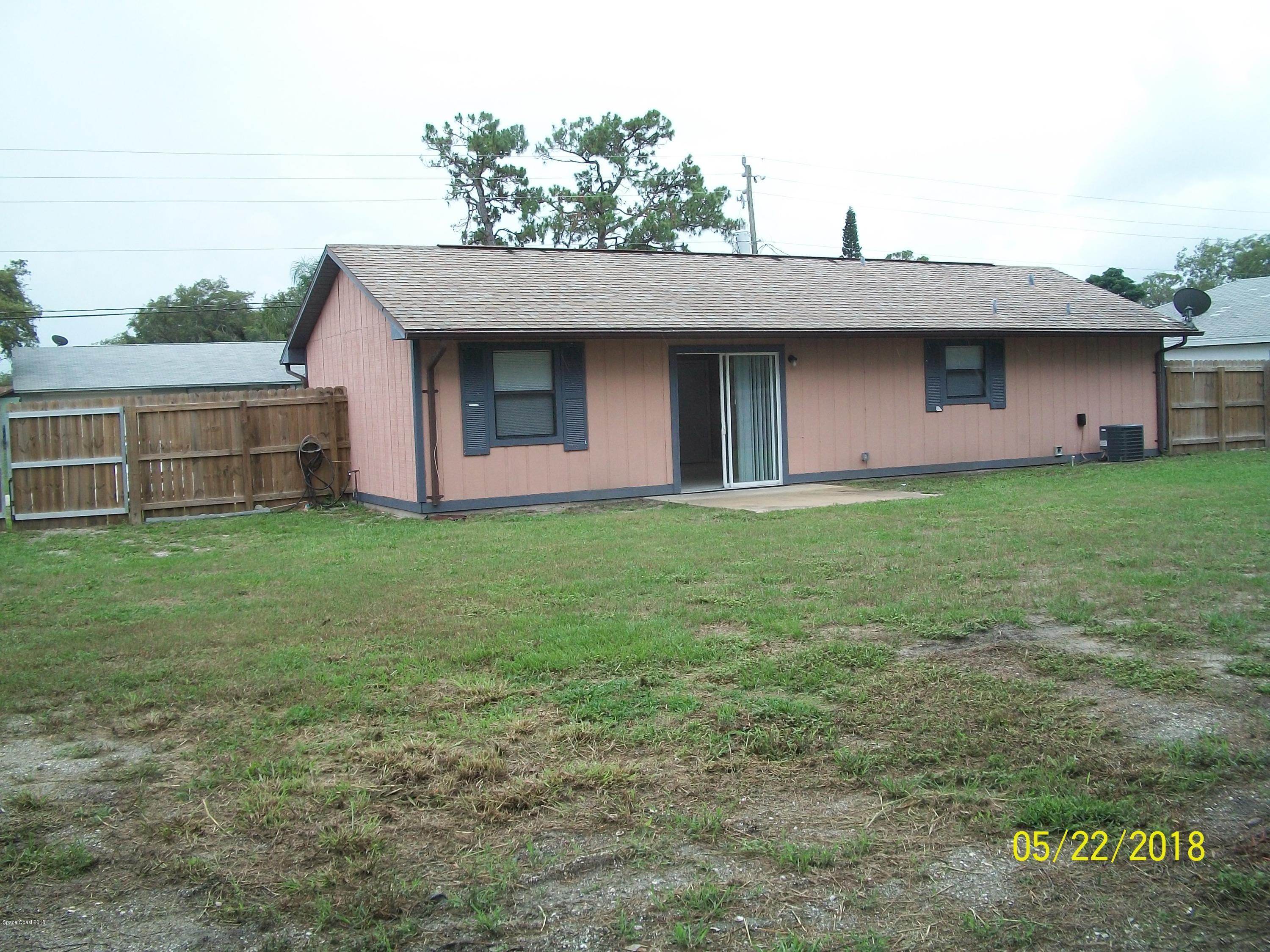 4910 Greenhill Street Cocoa, FL 32927 - Photo 3 of 11 a front view of a house with a yard