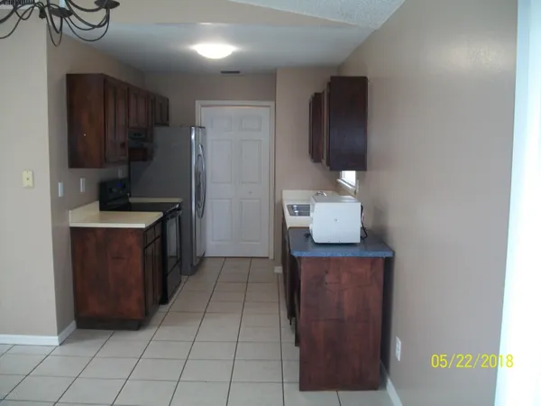 a kitchen with stainless steel appliances a refrigerator and a stove
