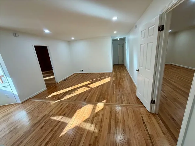a view of a room with wooden floor and staircase