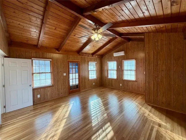 a view of room with wooden floors and stairs