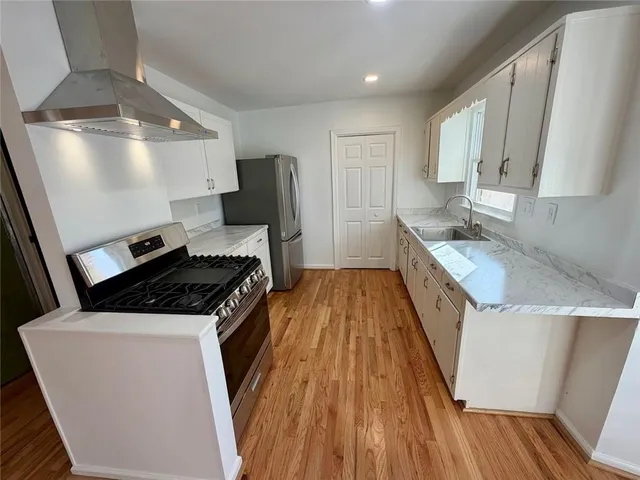 a kitchen that has a sink and a stove top oven