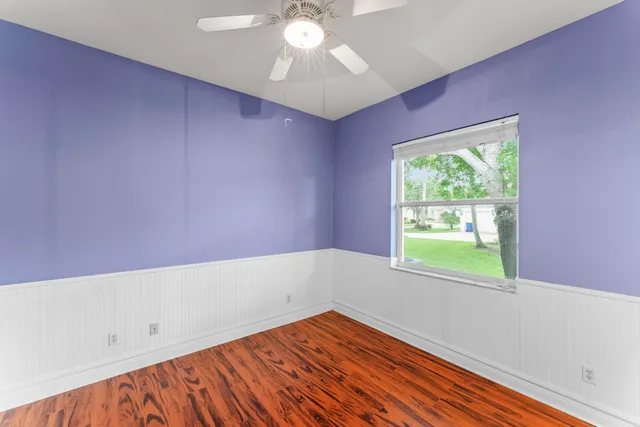 wooden floor in an empty room with a window