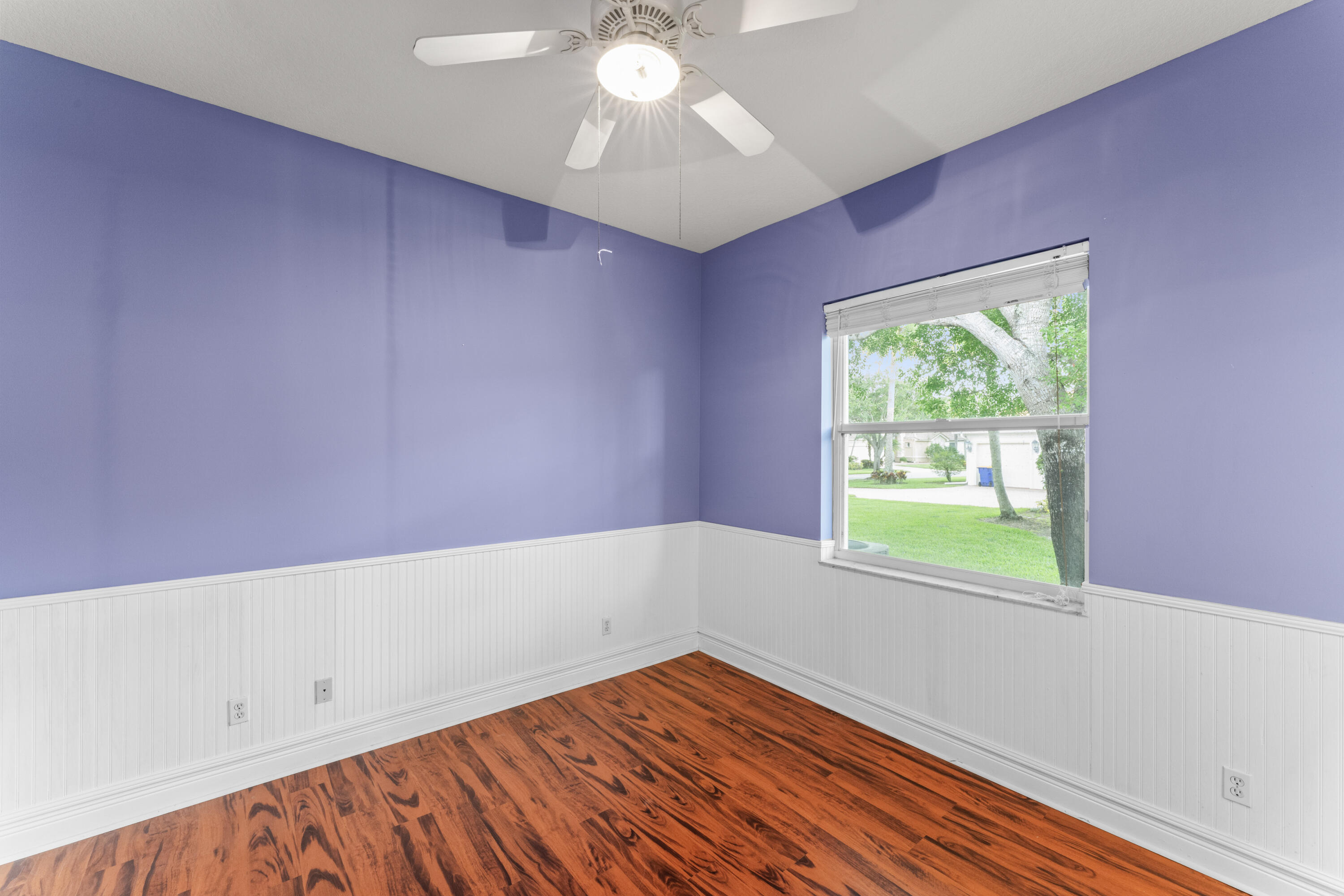 918 Southwest Blue Stem Way Stuart, FL 34997 - Photo 16 of 48 wooden floor in an empty room with a window