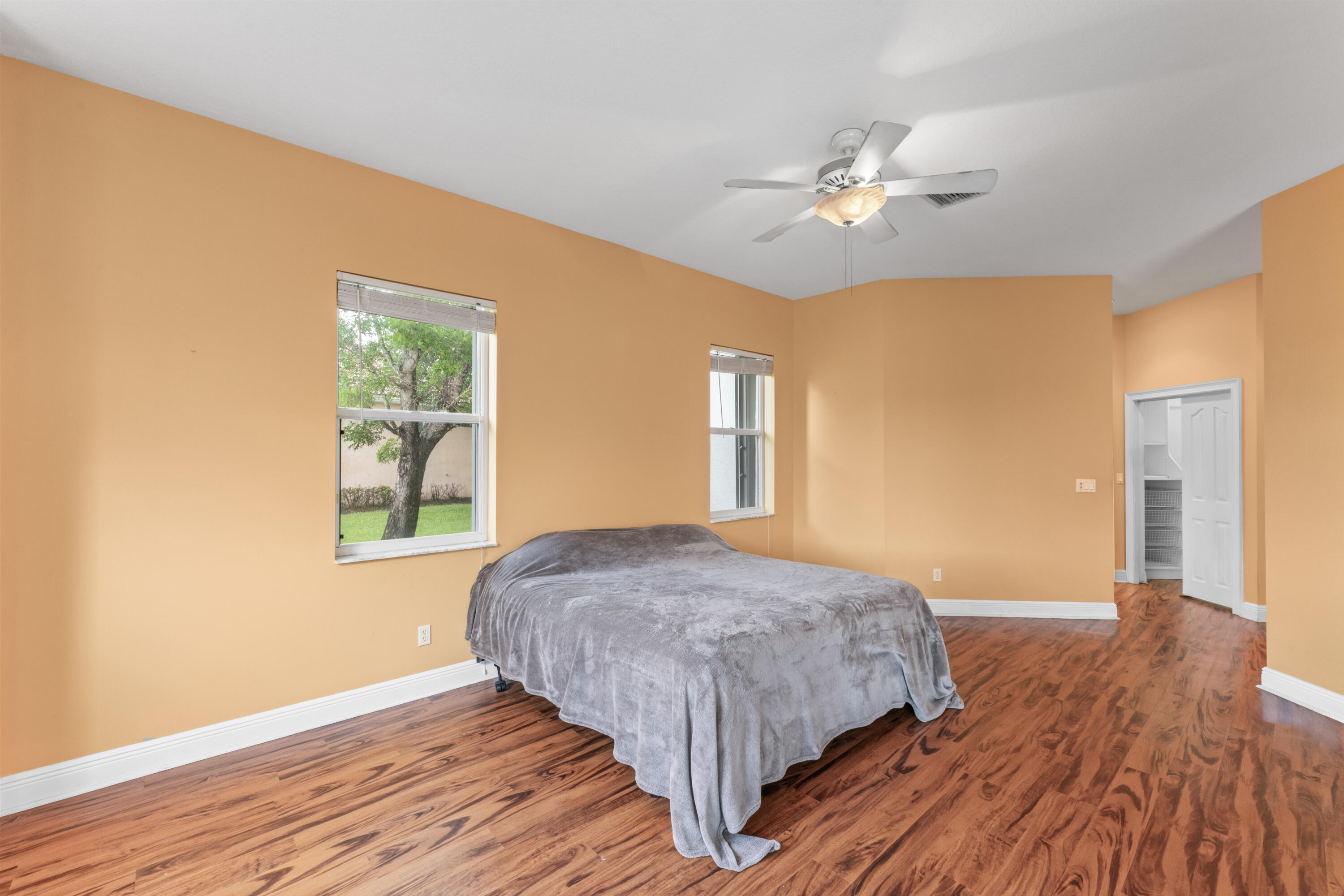 918 Southwest Blue Stem Way Stuart, FL 34997 - Photo 19 of 48 a bedroom with a bed and a chandelier