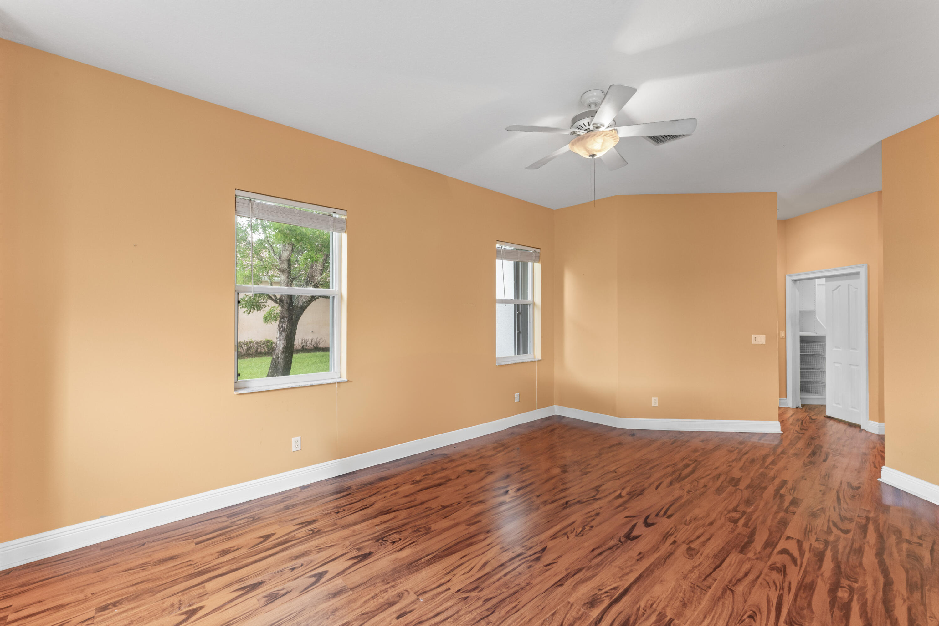 918 Southwest Blue Stem Way Stuart, FL 34997 - Photo 20 of 48 a view of empty room with wooden floor and fan