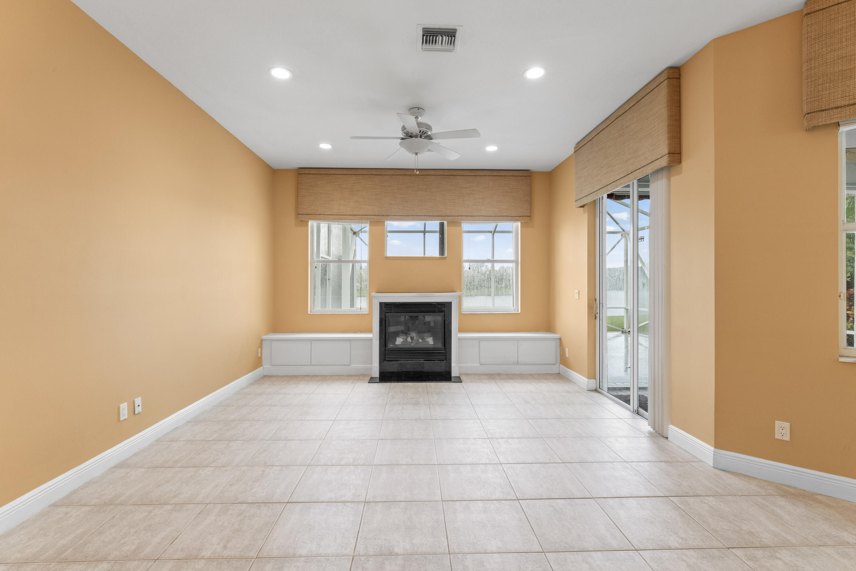 918 Southwest Blue Stem Way Stuart, FL 34997 - Photo 29 of 48 a view of an empty room with a fireplace and a window