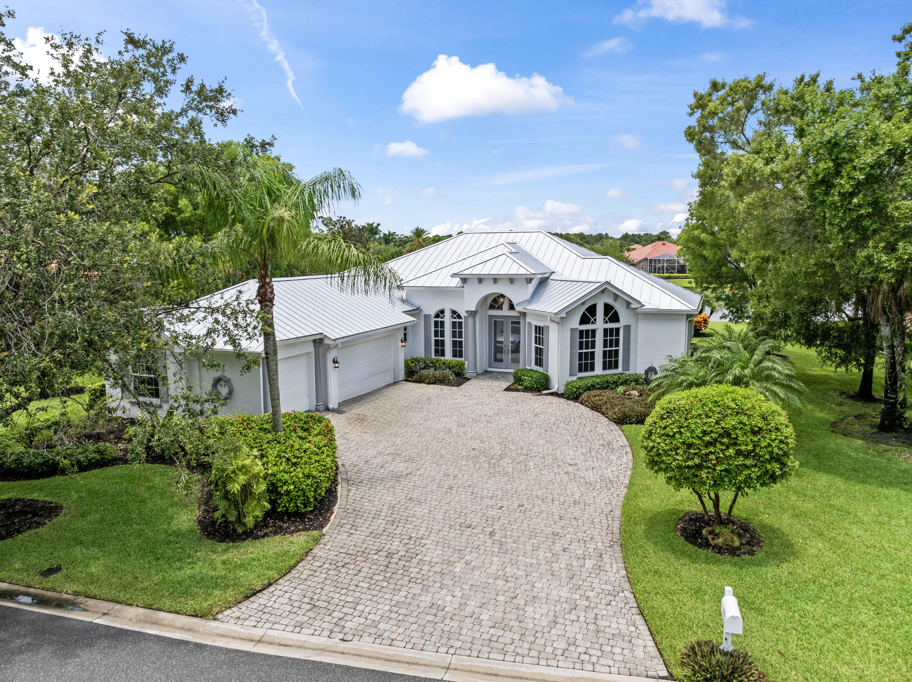 918 Southwest Blue Stem Way Stuart, FL 34997 - Photo 3 of 48 a front view of a house with a yard