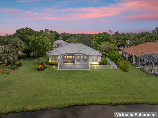 a front view of a house with garden and trees