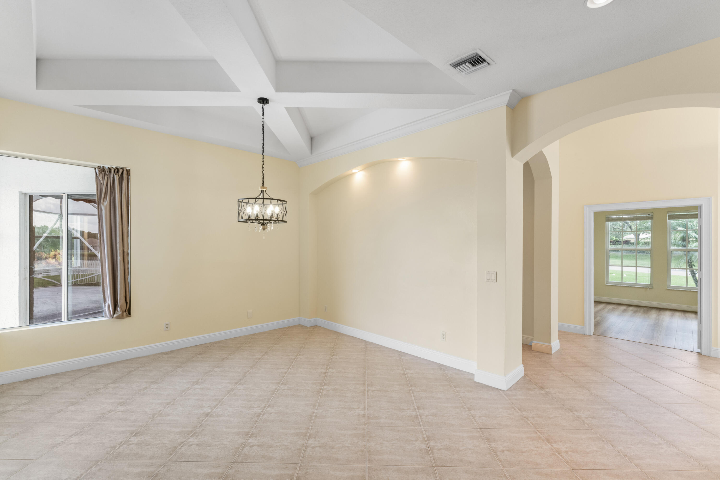 918 Southwest Blue Stem Way Stuart, FL 34997 - Photo 7 of 48 a view of an empty room with a window