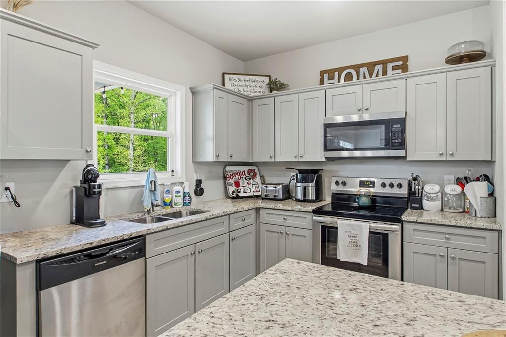 171 Strickland Loop Forsyth, GA 31029 - Photo 6 of 25 a kitchen with a sink stove top oven and microwave