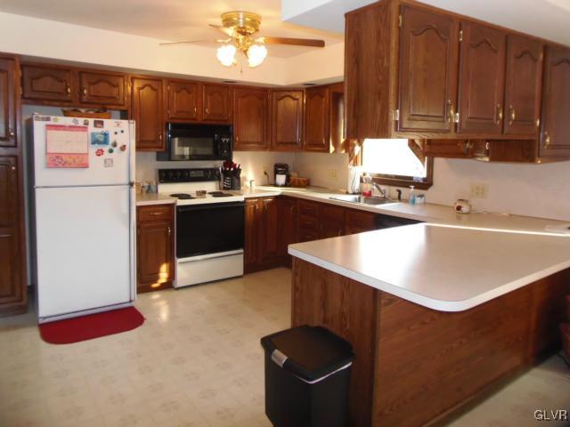 803 Copella Road Bath, PA 18014 - Photo 8 of 31 a kitchen with stainless steel appliances granite countertop a sink a stove and a refrigerator