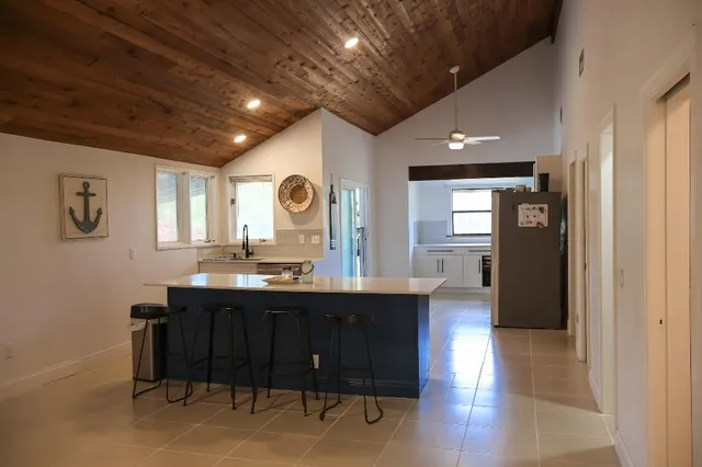 a view of a kitchen with a sink and a refrigerator