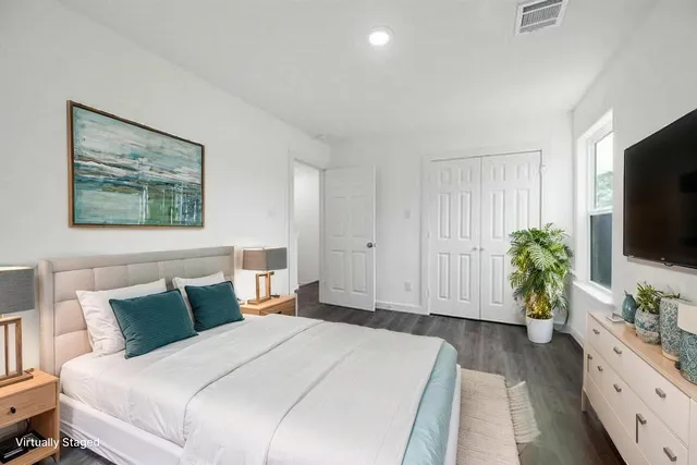 a bedroom with a bed and a flat screen tv