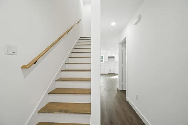 a view of entryway and gallery with wooden floor