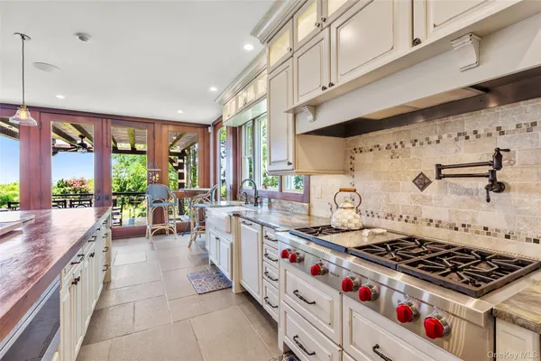a kitchen with stove a sink and cabinets