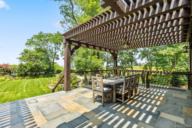 a view of a patio with table and chairs with wooden floor and fence