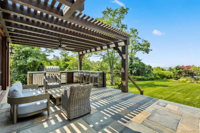 a view of a patio with couches chairs and wooden floor