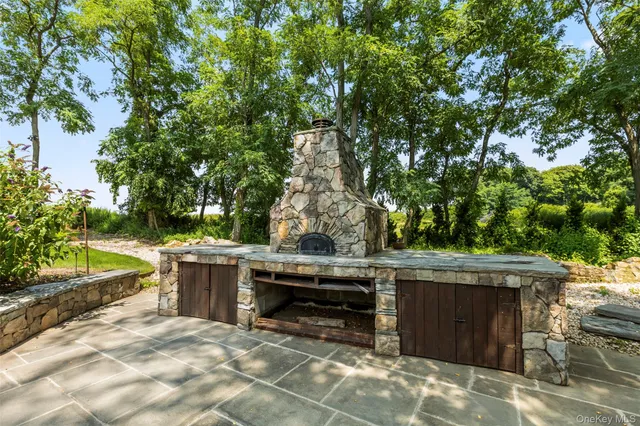a view of backyard with outdoor seating and trees