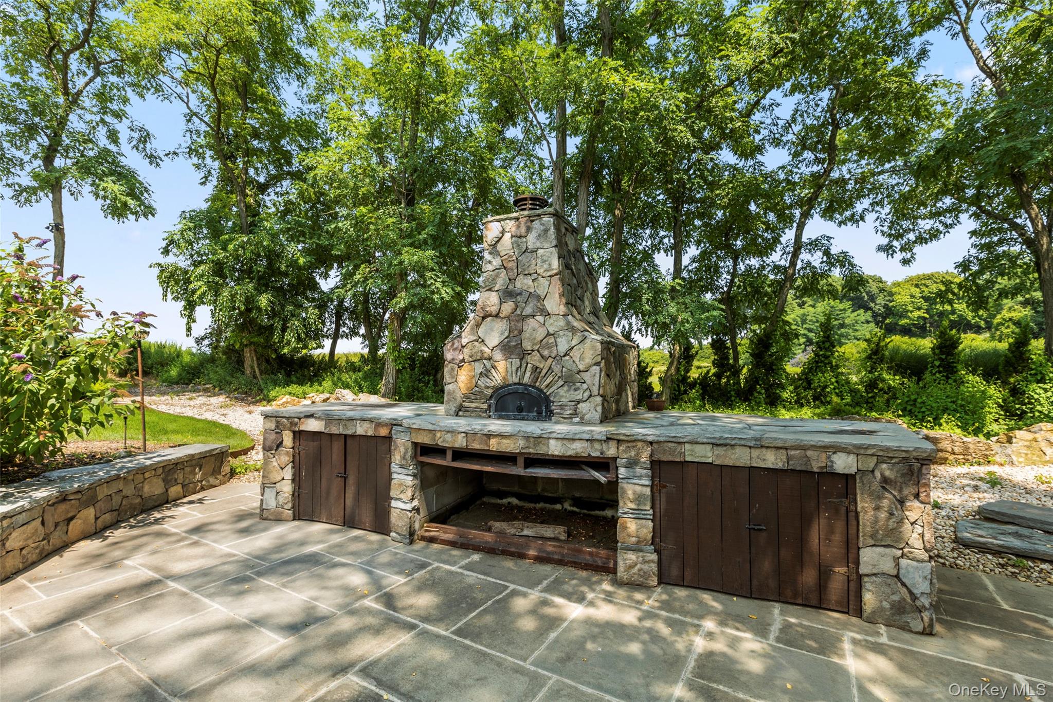 16 Old Field Woods Road Setauket, NY 11733 - Photo 16 of 37 a view of backyard with outdoor seating and trees
