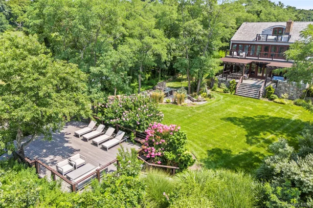 an aerial view of a house with swimming pool garden and patio
