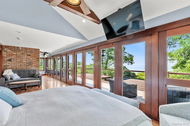 a bedroom with furniture and large windows