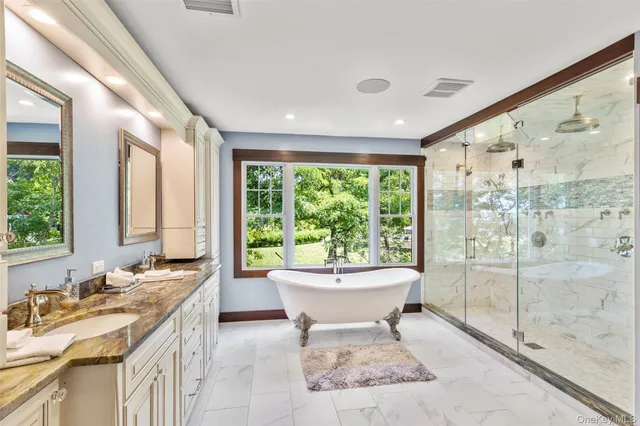 a bathroom with a granite countertop sink and a large mirror