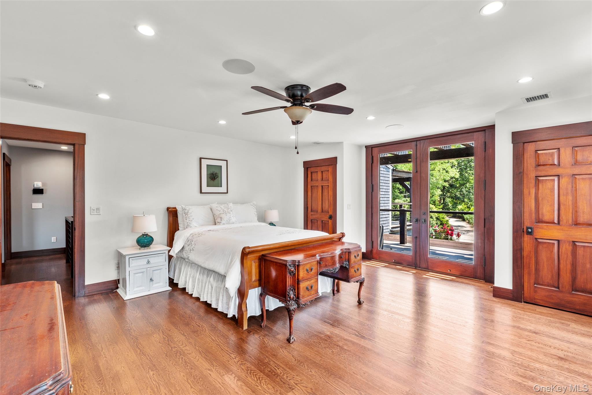 16 Old Field Woods Road Setauket, NY 11733 - Photo 26 of 37 a bedroom with a large bed and a chandelier