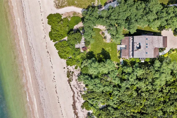 an aerial view of a house with a yard