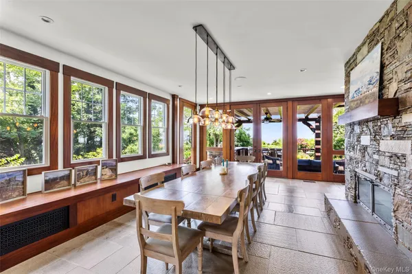 a dining room with furniture a chandelier and fireplace