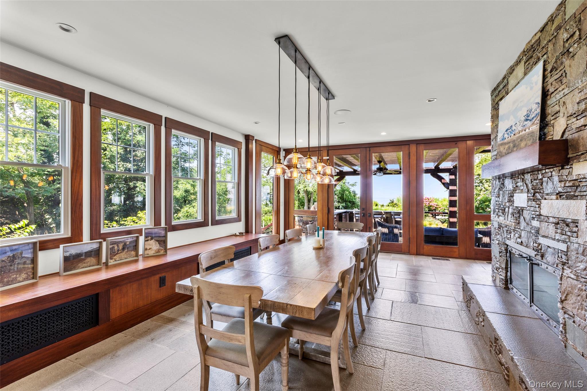 16 Old Field Woods Road Setauket, NY 11733 - Photo 7 of 37 a dining room with furniture a chandelier and fireplace