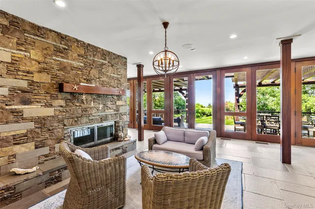 a living room with fireplace furniture and a large window