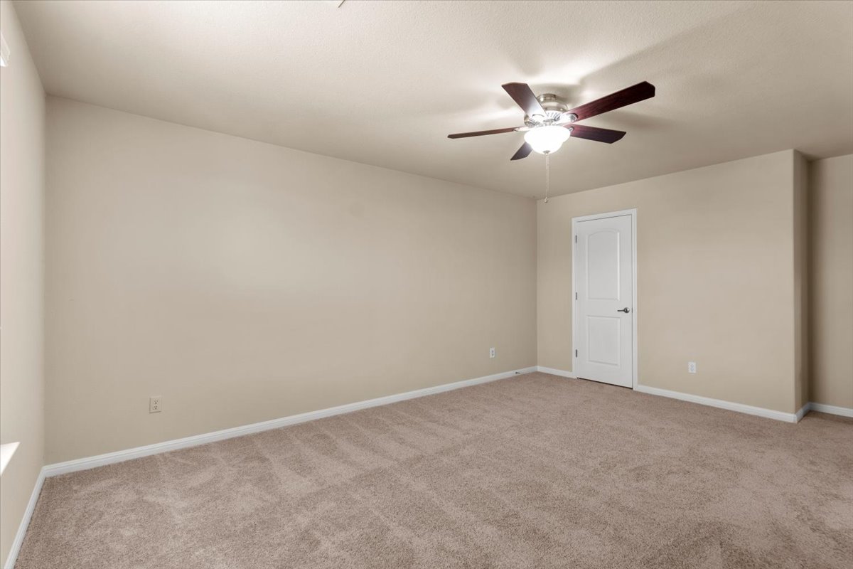 3451 Mayfield Ranch Boulevard, Unit 311 Round Rock, TX 78681 - Photo 32 of 40 Carpeted room with neutral wall tones and a ceiling fan with integrated lighting