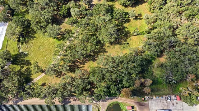a house with green field in front of it