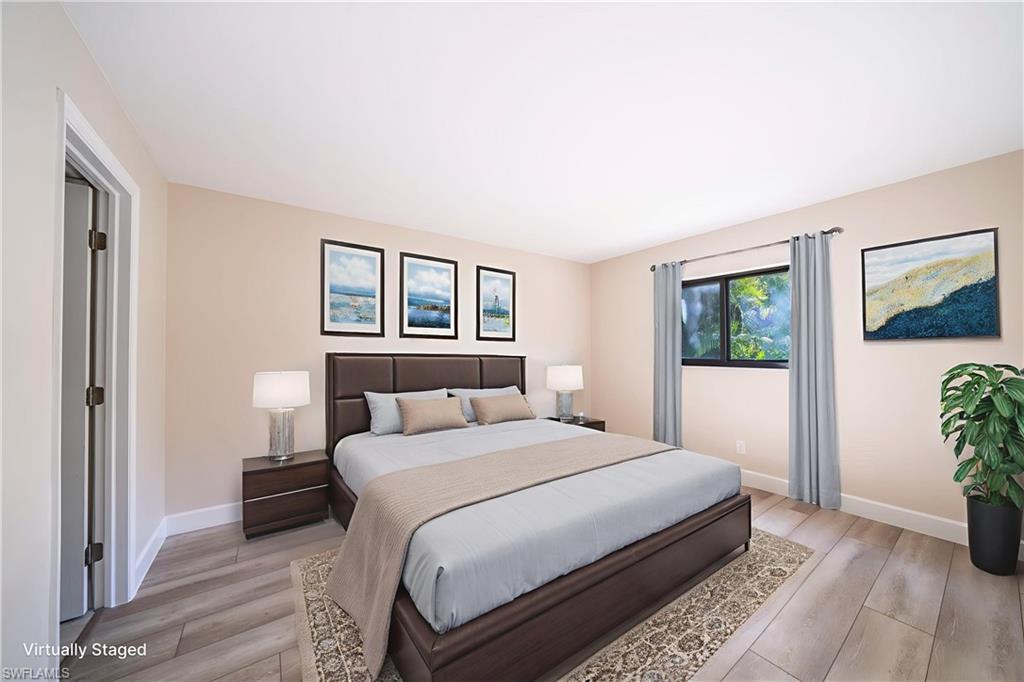 17455 Silver Fox Drive, Unit B Fort Myers, FL 33908 - Photo 11 of 19 Bedroom featuring light wood-style flooring and baseboards