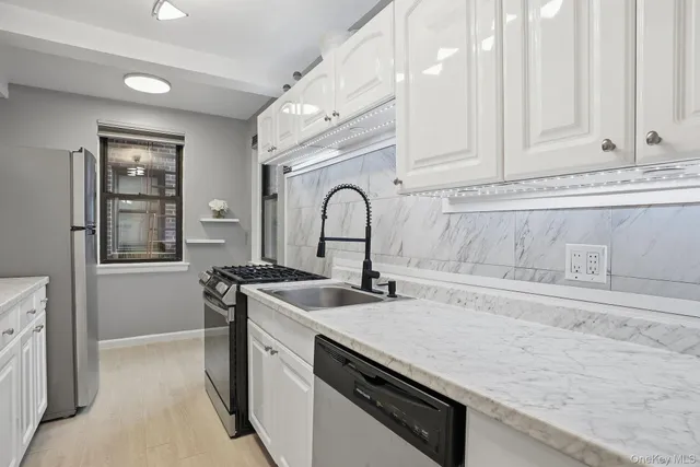 a kitchen with stainless steel appliances granite countertop a sink and cabinets
