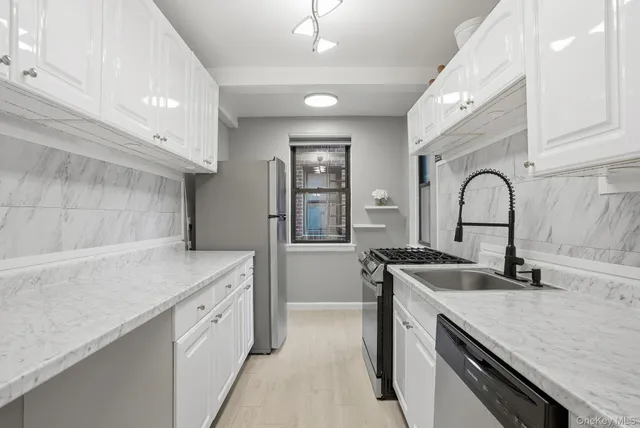 a kitchen with a sink and a stove top oven