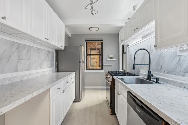 a kitchen with granite countertop a sink and cabinets