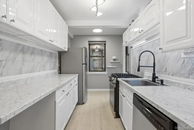a kitchen with a sink and a stove top oven