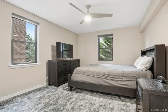 a bedroom with a bed and a tv on the dresser